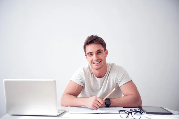 Cheerful smiling  man sitting at the table