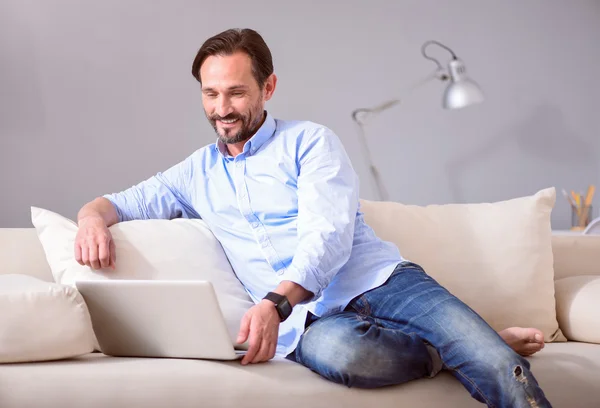 Man using laptop on the couch