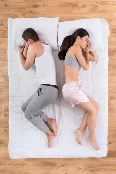 Man and woman sleeping together on bed