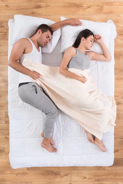 Nice couple sleeping on bed