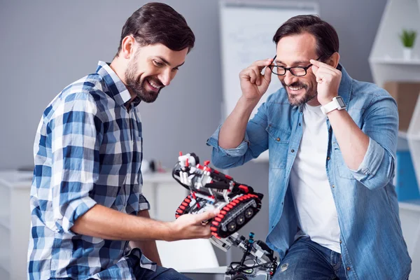 Cheerful colleagues testing robot