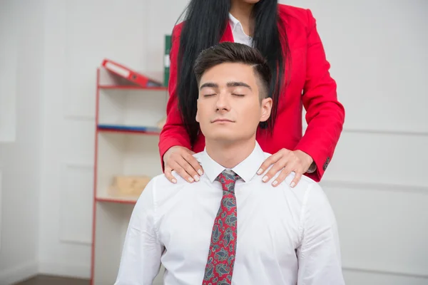 Woman doing massage to her colleague in office