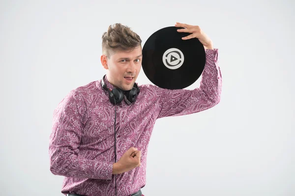 DJ posing with vinyl record and thumb up