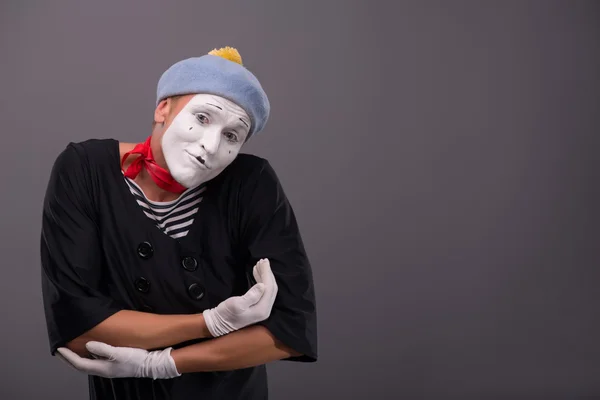 Portrait of young mime boy showing something with his hands