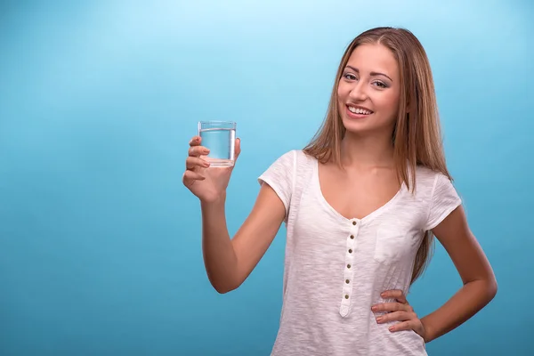 Girl holding a glass with clean water