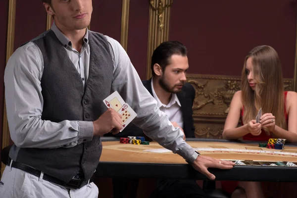 Man, beautiful woman and dealer  in casino