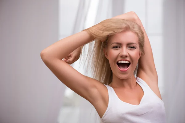 Blond girl smiling opening her mouth