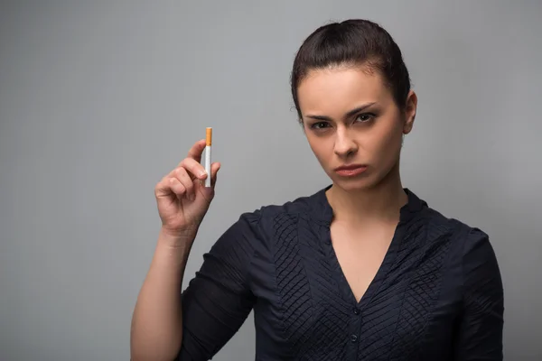 Determined girl holding cigarette