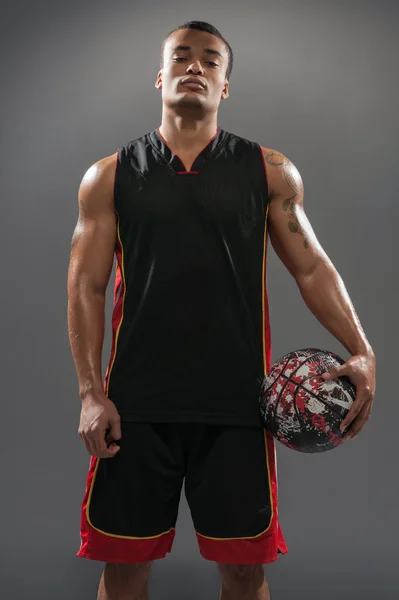 Young handsome African man posing with basketball ball