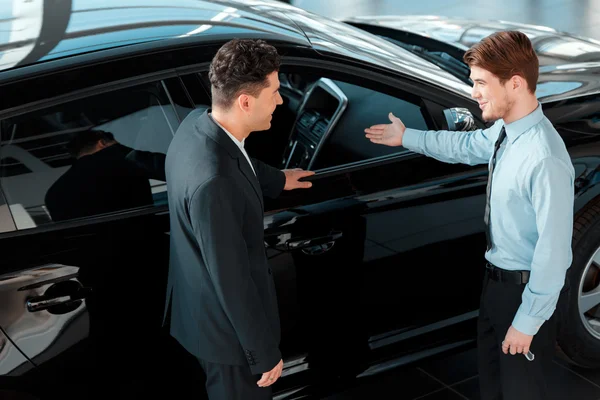 Car salesman talking to a customer