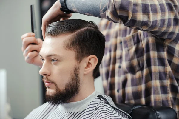 Man makes a haircut at barbershop