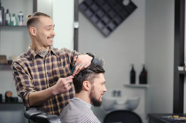 Barber cuts hair of a man