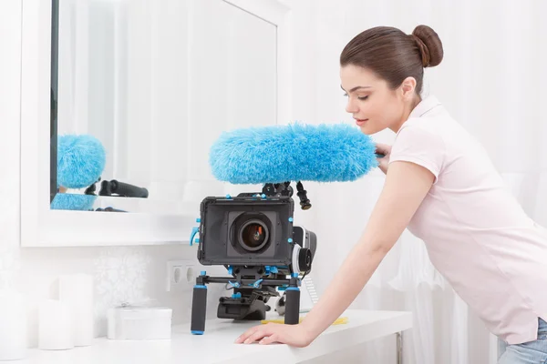 Young-looking lady posing with cleaning sweep