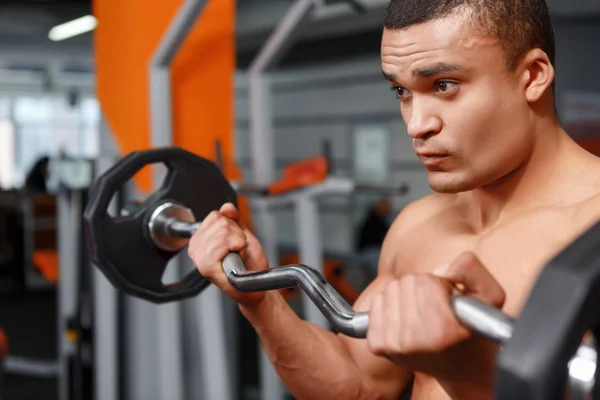 Portrait of weightlifter with barbell in his hands