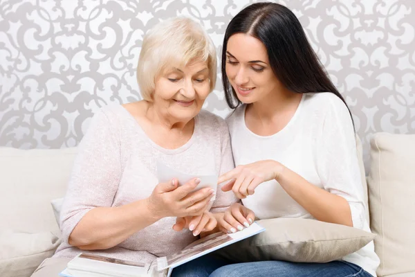 Granddaughter and her granny looking at photos