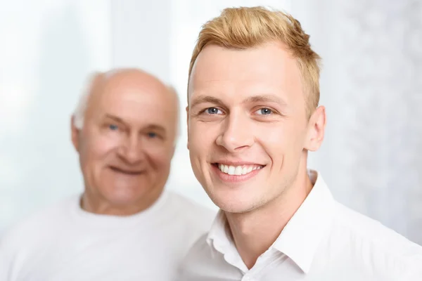 Close-up of grandson and grandfather