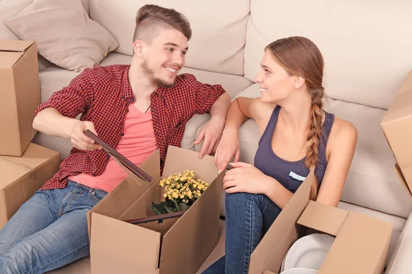 Young couple unpacking boxes