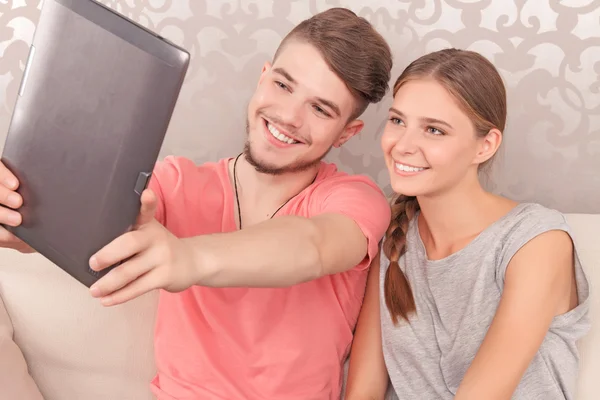 Nice couple holding laptop