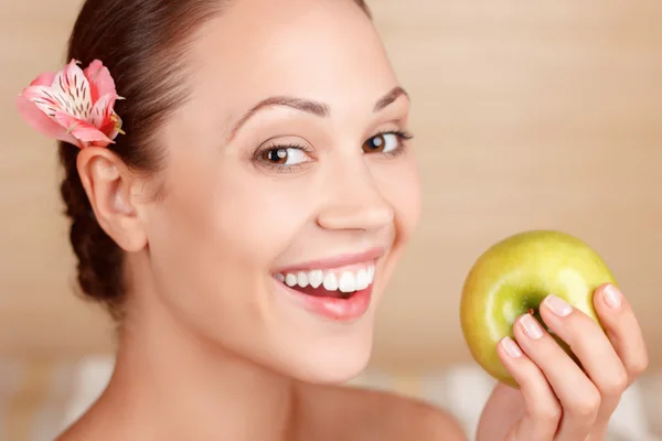 Smiling woman holding apple