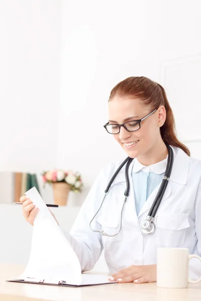 Professional doctor sitting at the table