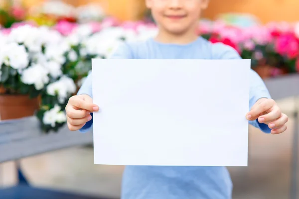 Little girl holding a paper.