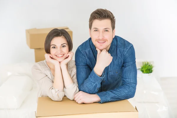 Positive couple leaning on the boxes