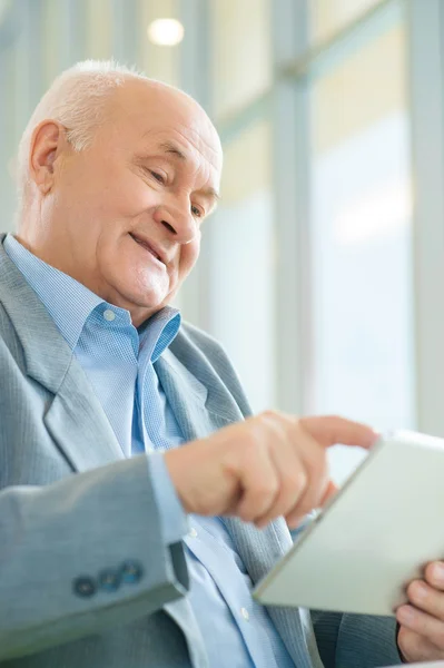 Shot of old man using digital tablet.