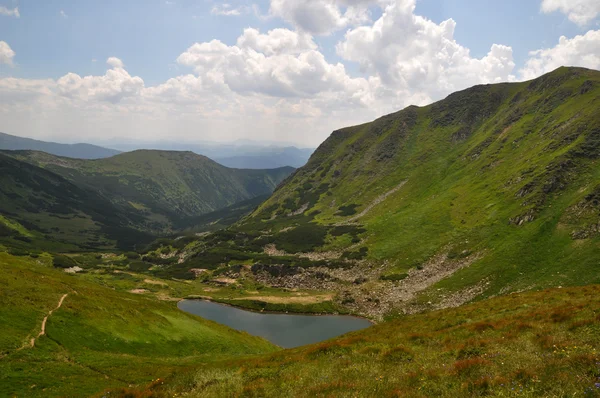 Most alpine lake Ukrainian Carpathian Mountains. Brebeneskul lake at the foot of the mountain Gutin-Tomnatyk.