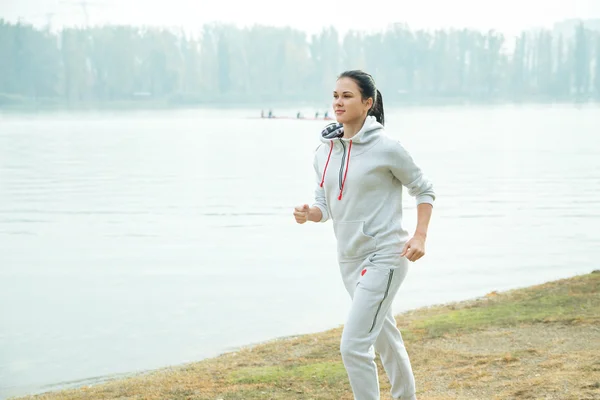 Female jogging outside in the park.