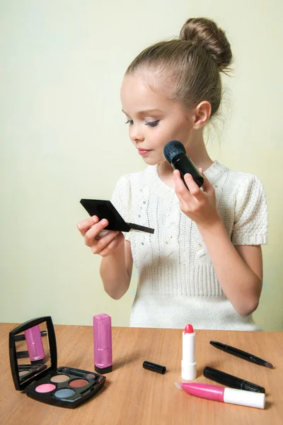 Fashion little girl applying make up