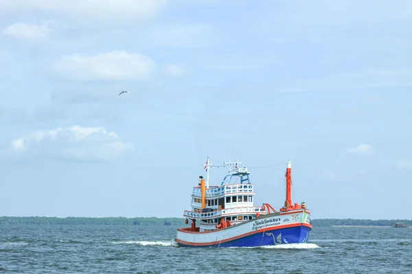 Boat in ocean under blue sky