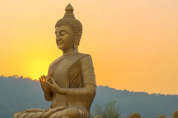 Golden Buddha and sunset