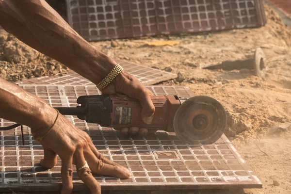 Man cutting floor tiles