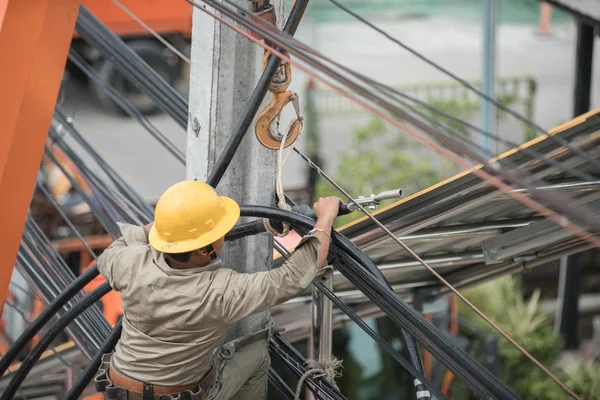 Electrician Man on electric poles. Electrical repairs are made t