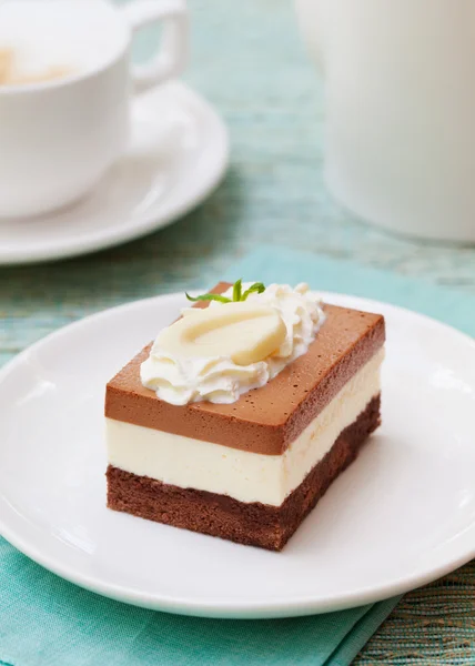 Three chocolate mousse cake on a white plate