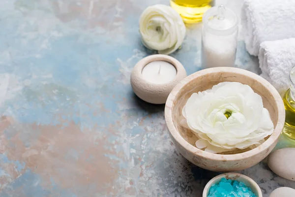 Spa and wellness massage setting, white floating ranunculus flowers