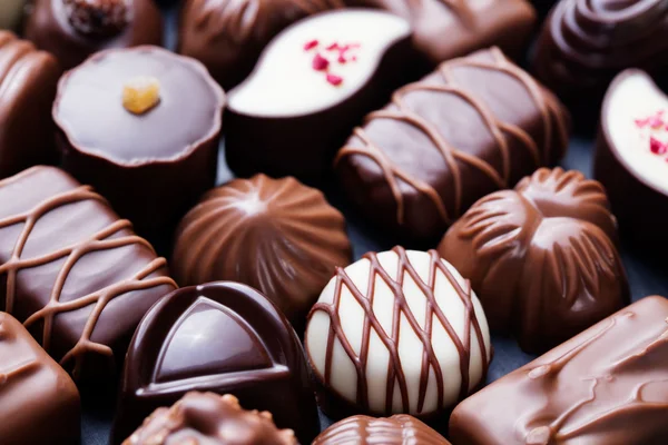 Assortment of fine chocolate candies, white, dark, and milk chocolate Sweets background