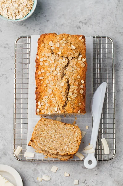 Healthy vegan oat and coconut loaf bread, cake on a cooling rack Top view