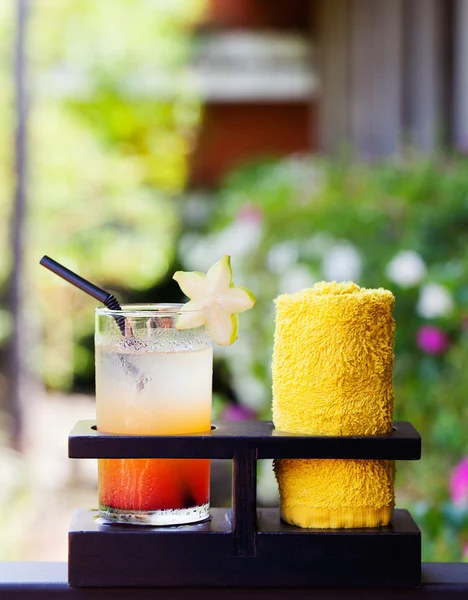 Tropical juice and cold towel, welcome drink in the hotel and spa Outdoor background