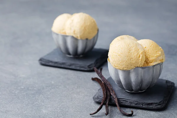 Vanilla Ice Cream with vanilla pods in metal vintage bowl.