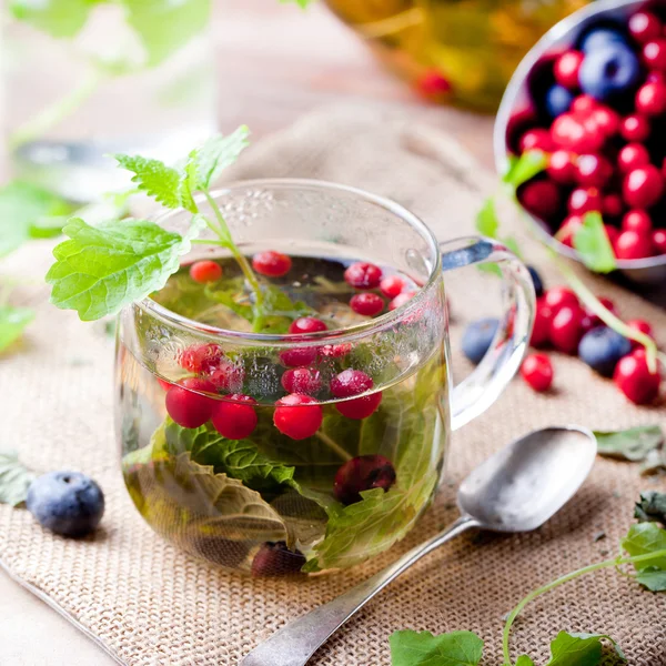 Herbal tea with fresh berries. Romantic autumn, summer background.