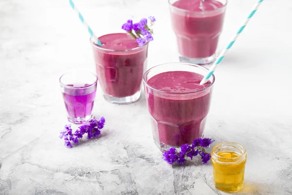 Blueberry, blackberry, honeysuckle, honeyberry smoothie with violet syrup and acai.