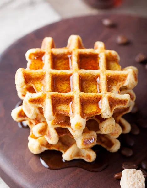 Whole wheat waffles with maple syrup and coffee
