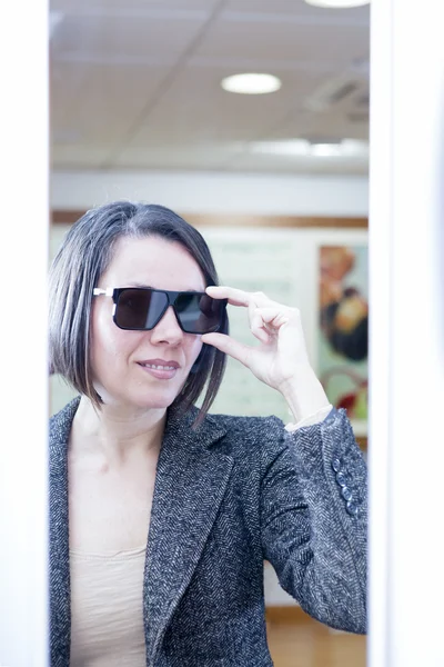 Woman trying on sunglasses