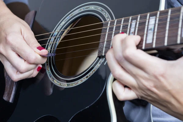 Female hand and guitar