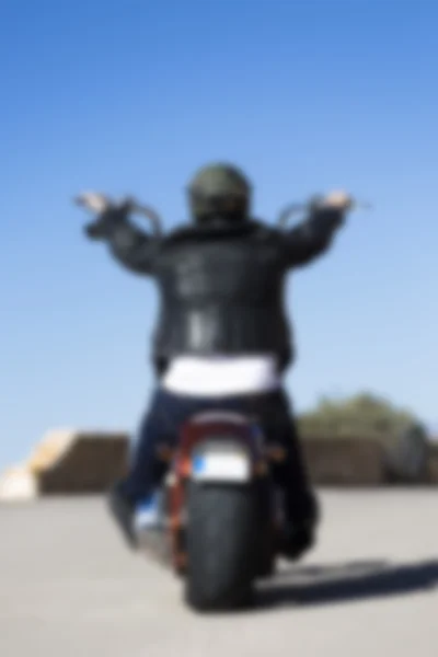 Rear view of a chopper motorcyclist driving