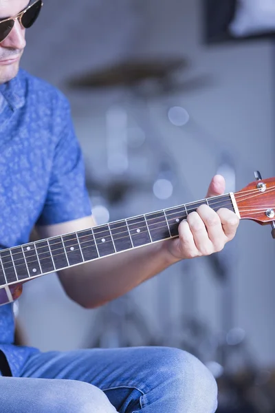 Hand on a guitar fret