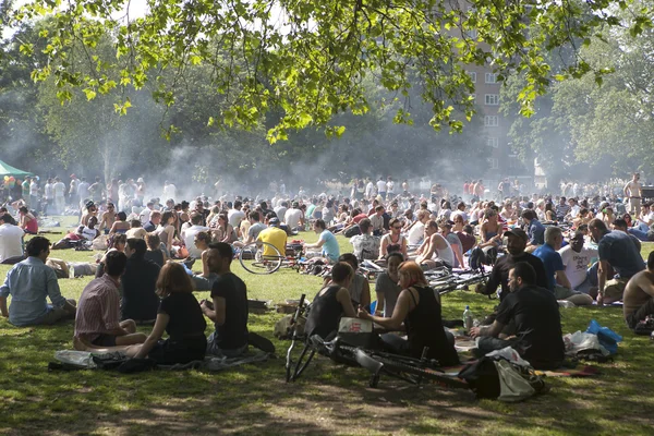 LONDON, UK - MAY 30: Young people are fried kebabs and rest in a local park in Hackney on May 30, 2014 in London, UK.