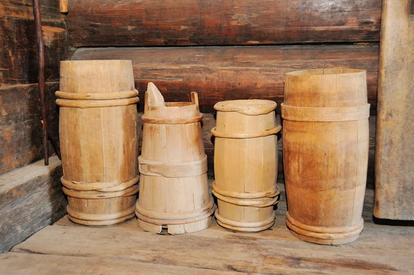 Many old wooden buckets in the old hut. Sauna