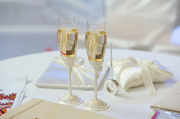 Two glasses with champagne standing on the table